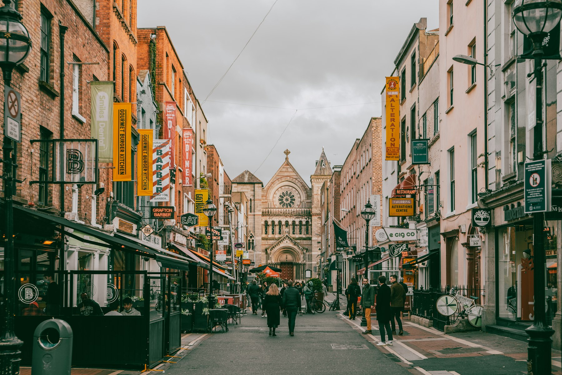 People walking down a colourful Dublin shopping street