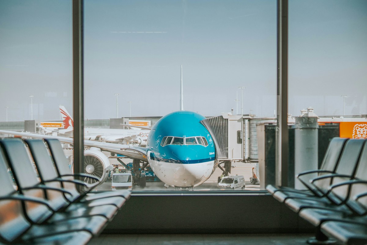 Airport departure lounge with a plane outside