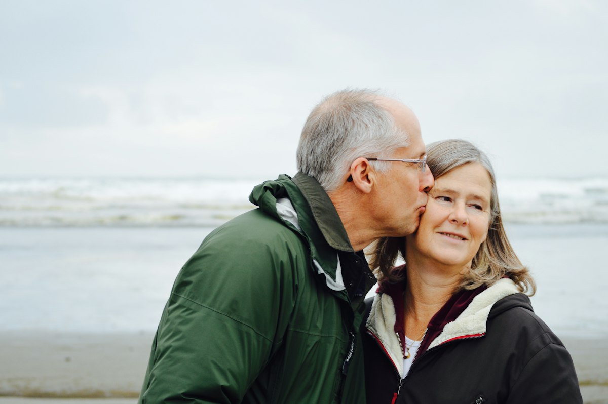 Older couple on a windswept beach