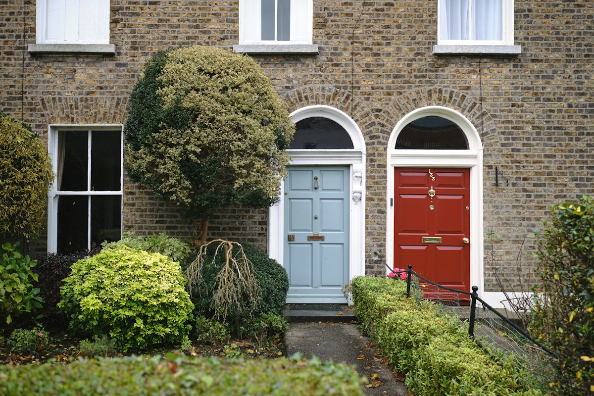 Brick terraced houses with coloured front doors in Sandymount, Dublin