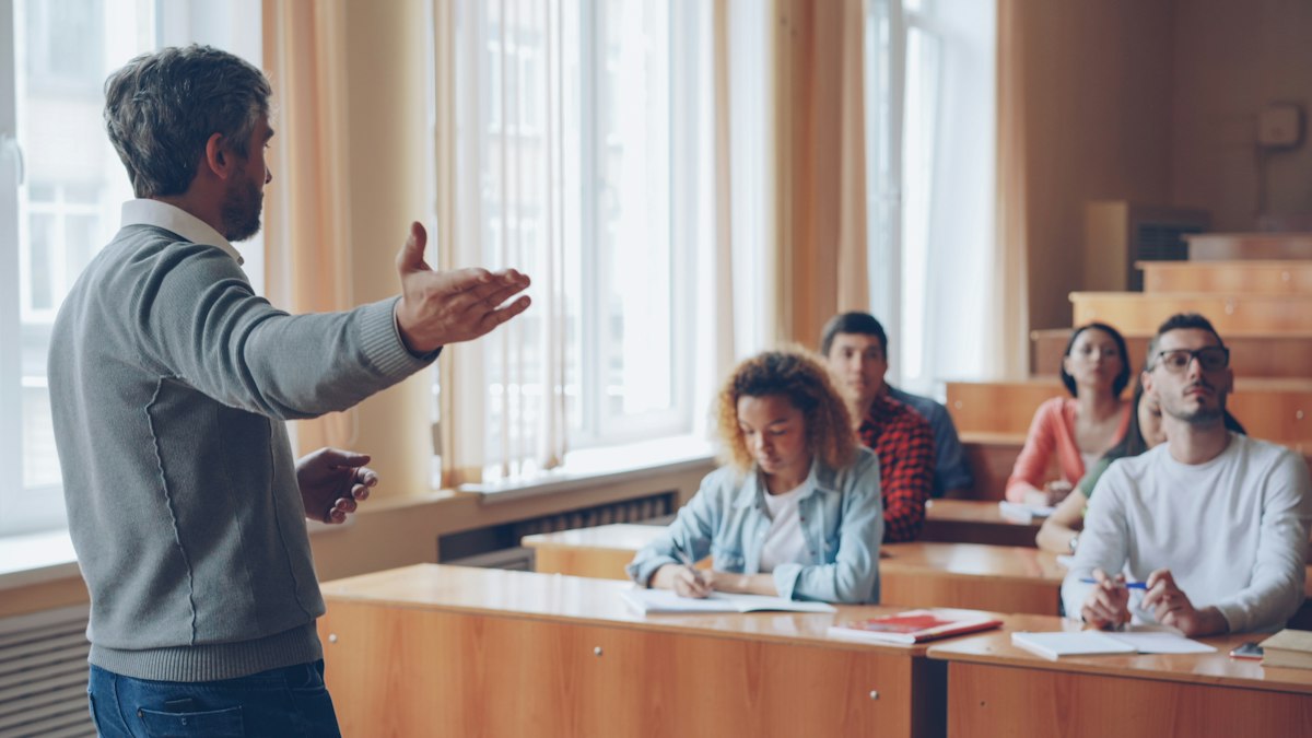 Teacher speaking to students in a classroom